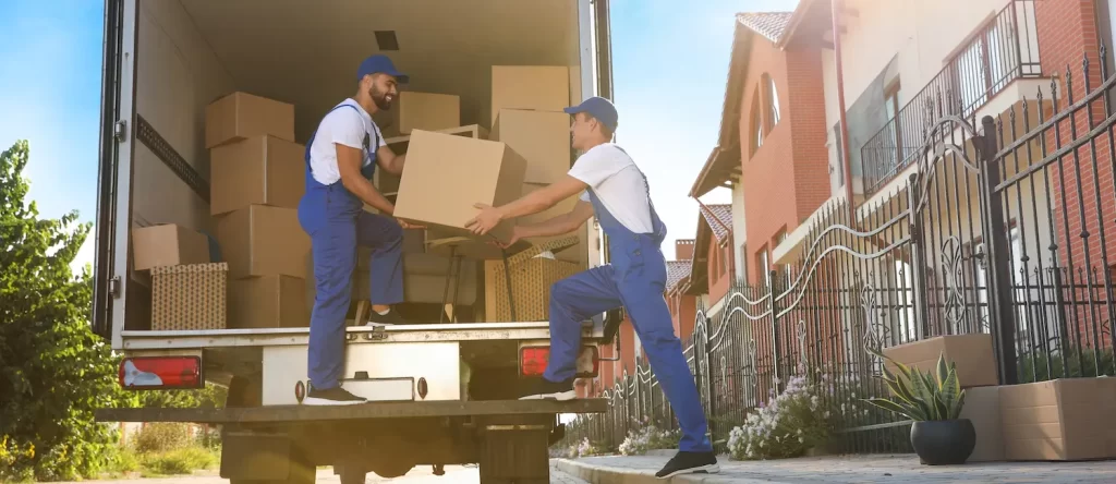 Professional movers carefully loading boxes onto a moving truck.