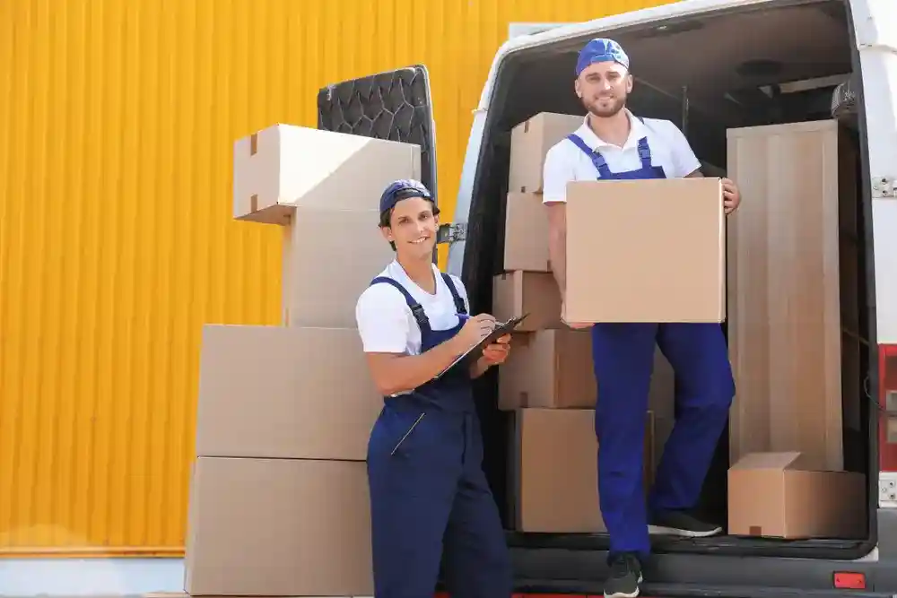 Professional interstate movers loading furniture onto a moving truck for a long-distance journey.