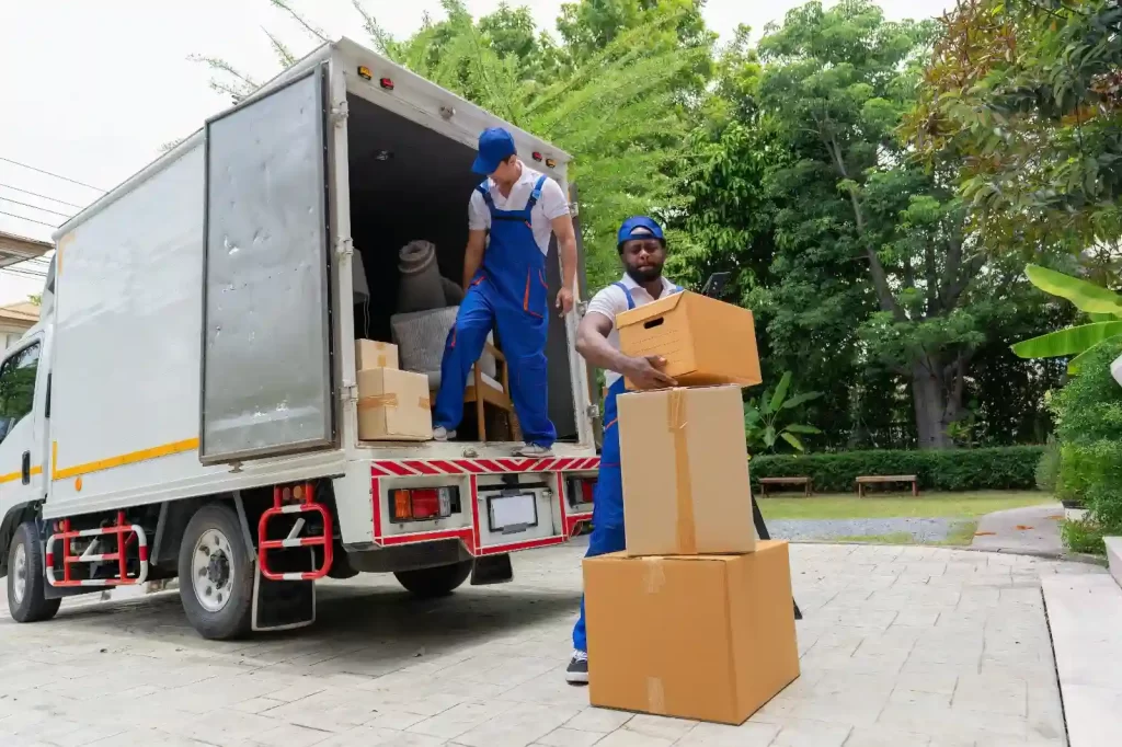 Top Moving Systems Lauderhill's expert movers loading belongings onto a long-distance transport vehicle.